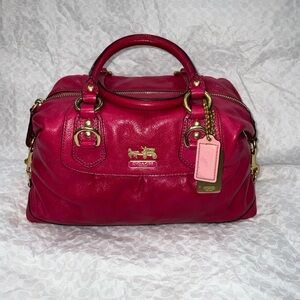 Coach Madison Sabrina satchel in a vibrant pink or fuchsia color.